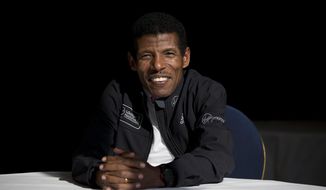 FILE - In this Wednesday, April 9, 2014 file photo, former marathon world record holder Ethiopia&#39;s Haile Gebrselassie, poses for photographers at a hotel in London. Gebrselassie says it was wrong to hold the track and field world championships in Qatar and marathon runners could have died from the heat. The women’s marathon Friday, Sept. 27, 2019 started at midnight to dodge the worst of the heat in Qatar but was still held in humidity that made it feel like 105 degrees (40 Celsius). Twenty-eight of the 68 women dropped out and one was briefly hospitalized. (AP Photo/Matt Dunham, File)