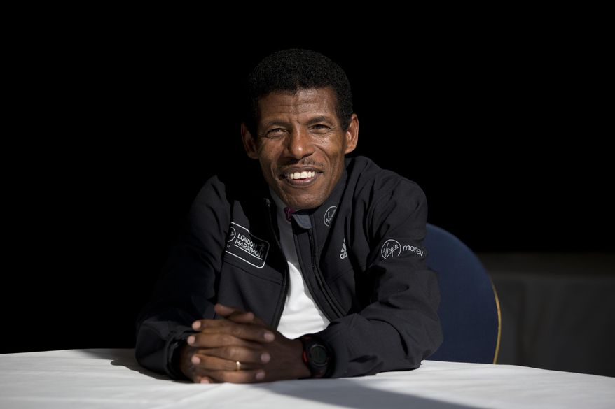 FILE - In this Wednesday, April 9, 2014 file photo, former marathon world record holder Ethiopia&#39;s Haile Gebrselassie, poses for photographers at a hotel in London. Gebrselassie says it was wrong to hold the track and field world championships in Qatar and marathon runners could have died from the heat. The women’s marathon Friday, Sept. 27, 2019 started at midnight to dodge the worst of the heat in Qatar but was still held in humidity that made it feel like 105 degrees (40 Celsius). Twenty-eight of the 68 women dropped out and one was briefly hospitalized. (AP Photo/Matt Dunham, File)