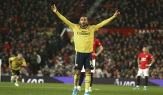 Arsenal&#39;s Pierre-Emerick Aubameyang celebrates after scoring the opening goal during the English Premier League soccer match between Manchester United and Arsenal at Old Trafford in Manchester, England, Monday, Sept. 30, 2019. (AP Photo/Dave Thompson)