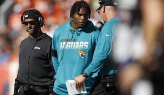 Jacksonville Jaguars cornerback Jalen Ramsey, center, talks with defensive coordinator Todd Wash as he stands on the sidelines during the first half of an NFL football game against the Denver Broncos, Sunday, Sept. 29, 2019, in Denver. (AP Photo/David Zalubowski)