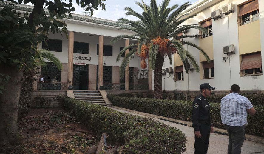 Guards stand outside court where journalist Hajar Rissouni was delivered a one year prison sentence on accusations of her undergoing an illegal abortion, in Rabat, Morocco, Monday, Sept. 30, 2019. The 28-year old Moroccan journalist Hajar Raissouni was sentenced to one year in prison, Monday, while her fiancé also received a one-year sentence and the doctor accused of terminating the pregnancy was sentenced to two years in jail and suspended from practicing. (AP Photo/Mosa'ab Elshamy)
