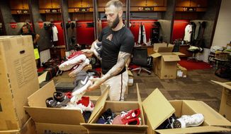 Arizona Diamondbacks&#39; Christian Walker places shoes in boxes while cleaning out his locker after their 1-0 win over the San Diego Padres Sunday, Sept. 29, 2019, in Phoenix. The Arizona Diamondbacks finished the season with 85 wins and 77 loses. (AP Photo/Darryl Webb)