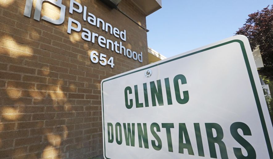 In this Aug. 21, 2019 file photo, a sign is displayed at Planned Parenthood of Utah in Salt Lake City. Senate Republicans have set up votes on two bills in the last week of February that would criminalize some abortion procedures after 20 weeks of pregnancy. The vote could put Democrats on the spot about how far they would go in supporting abortion rights. (AP Photo/Rick Bowmer)