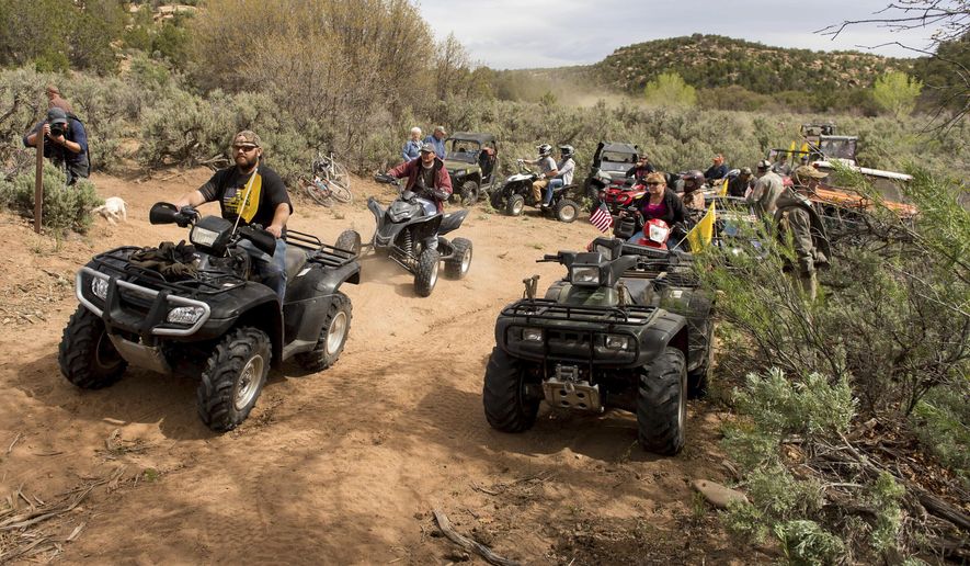 FILE - In this May 10, 2014, file photo, people ride ATV's into Recapture Canyon north of Blanding, Utah, in a protest against what demonstrators call the federal government's overreaching control of public lands. ATVs will be allowed on certain roads in the five national parks in Utah under a new rule from the National Park Service that went through without public comment. (Trent Nelson/The Salt Lake Tribune via AP, File)