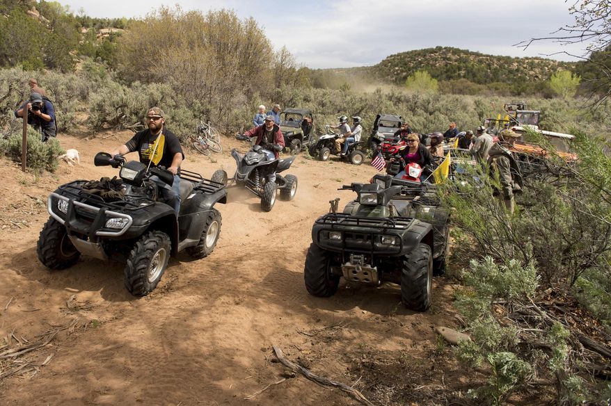 FILE - In this May 10, 2014, file photo, people ride ATV's into Recapture Canyon north of Blanding, Utah, in a protest against what demonstrators call the federal government's overreaching control of public lands. ATVs will be allowed on certain roads in the five national parks in Utah under a new rule from the National Park Service that went through without public comment. (Trent Nelson/The Salt Lake Tribune via AP, File)
