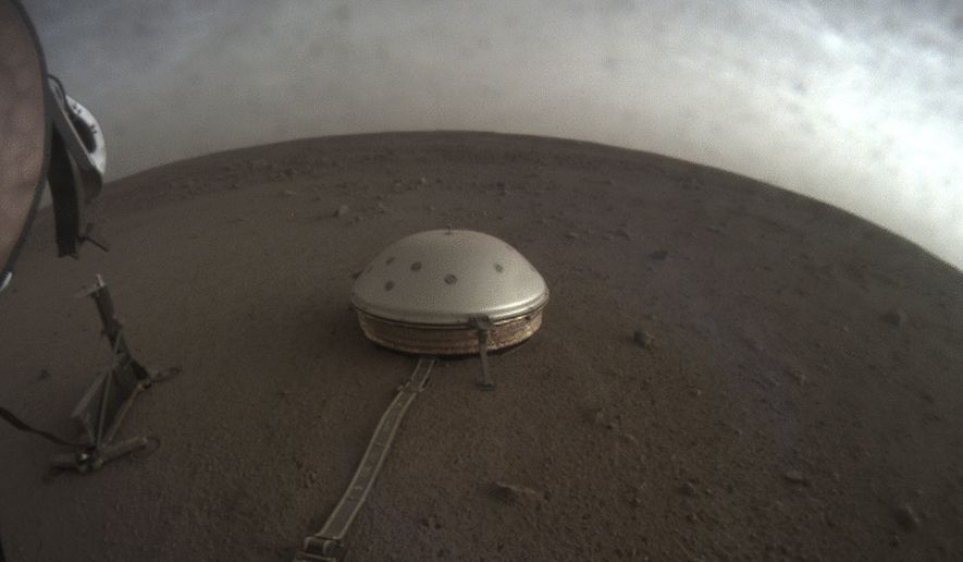 This April 25, 2019, file photo made available by NASA shows the InSight lander's dome-covered seismometer, known as SEIS, on Mars. On Tuesday, Oct. 1, 2019, scientists released an audio sampling of marsquakes and other sounds recorded by the probe. (NASA/JPL-Caltech via AP)