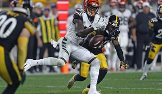 Cincinnati Bengals wide receiver Auden Tate (19) cannot hang onto a pass from quarterback Andy Dalton with Pittsburgh Steelers cornerback Cameron Sutton (20) defending during the second half of an NFL football game in Pittsburgh, Monday, Sept. 30, 2019. (AP Photo/Tom Puskar)