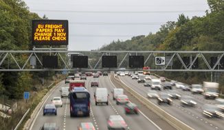 A motorway overhead matrix sign on the M3 motorway warms motorists about possible changes to EU freight papers, near Camberley, south-east England, Monday Sept. 30, 2019.  Uncertainty persists over Britain&#39;s Brexit split from the European Union bloc, although Britain&#39;s Prime Minister Boris Johnson has vowed that Britain will leave on the scheduled date of Oct. 31, with or without a deal. (Steve Parsons/PA via AP)