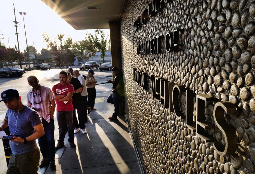 In this Tuesday, Aug. 7, 2018, file photo, people line up at the California Department of Motor Vehicles prior to opening in the Van Nuys section of Los Angeles. A Republican lawyer who has waged lawsuits on behalf of the Trump administration is suing California and the state DMV, saying the agency is failing to verify whether non-citizens are being registered to vote. (AP Photo/Richard Vogel, File)