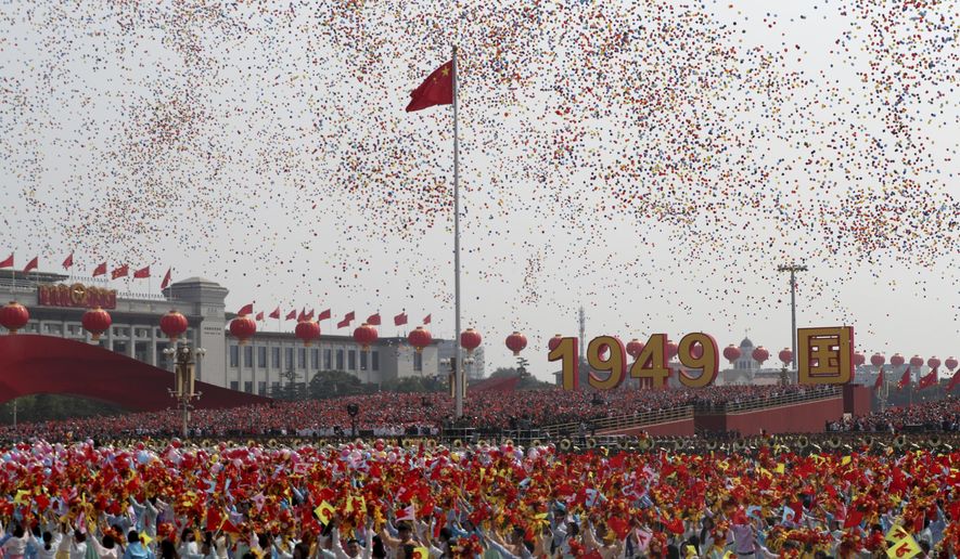 Balloons are released during the 70th anniversary of the founding of the People&#39;s Republic of China in Beijing on Tuesday, Oct. 1, 2019. (AP Photo/Ng Han Guan)