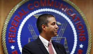 In this Dec. 14, 2017, file photo, after a meeting voting to end net neutrality, Federal Communications Commission (FCC) Chairman Ajit Pai smiles while listening to a question from a reporter in Washington. A federal court is ruling that the FCC had the right to dump net-neutrality rules, but couldn&#39;t bar states like California from passing their own. The ruling is largely a victory for Pai. (AP Photo/Jacquelyn Martin, File)