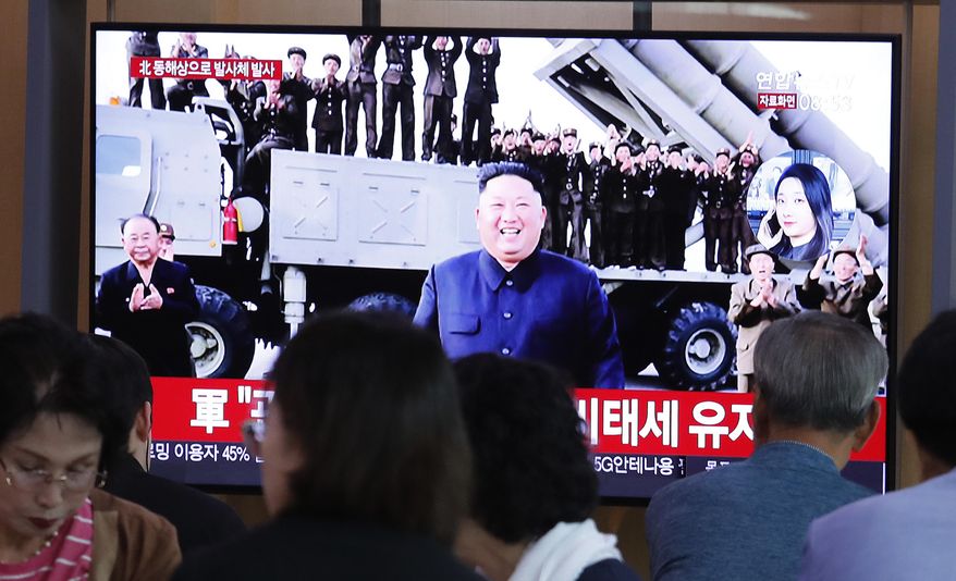 People watch a TV showing a file image of North Korean leader Kim Jong-un during a news program at the Seoul Railway Station in Seoul, South Korea, Wednesday, Oct. 2, 2019. North Korea on Wednesday fired projectiles toward its eastern sea, South Korea's military said, in an apparent display of its expanding military capabilities ahead of planned nuclear negotiations with the United States this weekend. (AP Photo/Ahn Young-joon)