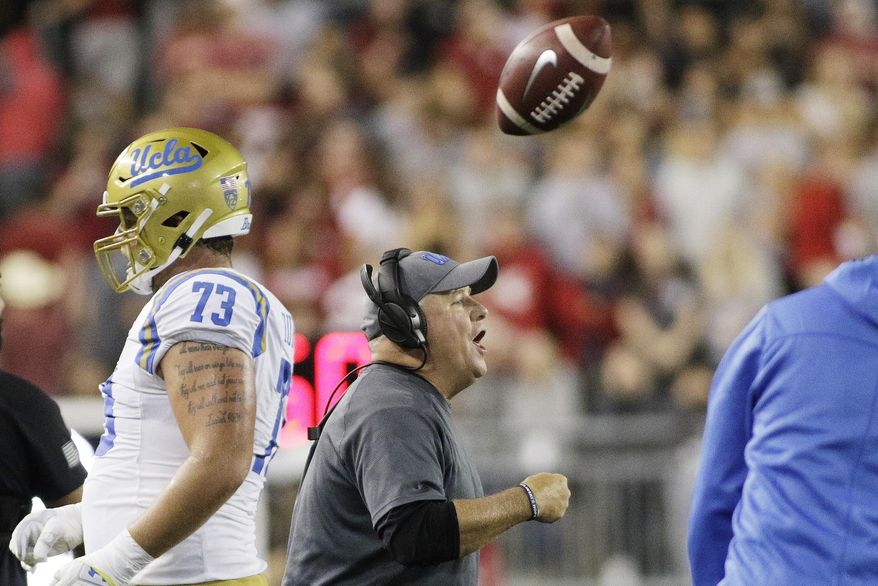 UCLA head coach Chip Kelly, center, shouts to his players during the first half of an NCAA college football game against Washington State in Pullman, Wash., Saturday, Sept. 21, 2019. (AP Photo/Young Kwak)