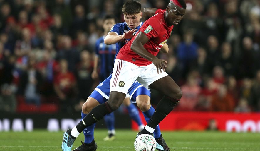 Rochdale&#39;s Aaron Morley, left, and Manchester United&#39;s Paul Pogba battle for the ball during their English League Cup, Third Round soccer match at Old Trafford, Manchester, England, Wednesday, Sept. 25, 2019. (Richard Sellers/PA via AP)
