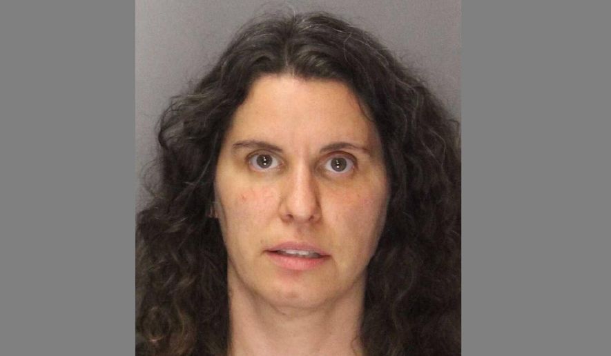 FILE - This Sept. 13, 2019, file photo booking photo shows Rebecca Dalelio, 43, who was arrested and jailed in the County Main Jail in Sacramento, Calif. California police have arrested Dalelio, who threw a feminine hygiene device containing "what appeared to be blood" onto the floor of the state Senate on Friday, splashing onto lawmakers and forcing them to finish their work in a committee room on the final day of the legislative session. Test results have confirmed the red liquid thrown on the floor of the California Senate last month was human blood, but it did not contain pathogens or infections. The California Senate was delayed for several hours on the final day of the legislative session last month after a woman threw blood from the public gallery, some of which landed on several senators. Wednesday, Oct. 2, 2019, a letter from Secretary of the Senate Erika Contreras said the chamber is now open to the public. (Sacramento County Sheriff's Office via AP, File)