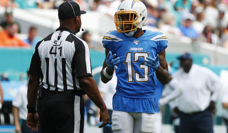 Los Angeles Chargers wide receiver Keenan Allen (13) argues a call with side judge Anthony Jeffries, during the first half at an NFL football game against the Miami Dolphins, Sunday, Sept. 29, 2019, in Miami Gardens, Fla. Allen's touchdown was nullified due to offensive pass interference, (AP Photo/Wilfredo Lee)