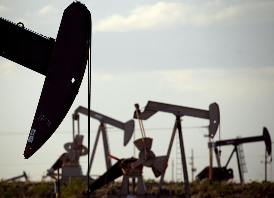 FILE - In this April 24, 2015, file photo, pumpjacks work in a field near Lovington, N.M. Satellite imagery and supercomputing capabilities will be used to detect and monitor methane pollution from major oil and natural gas installations in New Mexico, under an informal partnership announced Thursday, Sept. 19, 2019, between state regulators and private-sector data cruncher Descartes Labs. (AP Photo/Charlie Riedel, File)