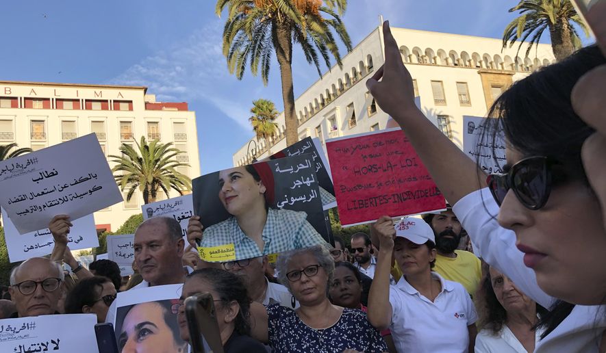 Demonstrators, including prominent activists and journalists, demonstrate in front of Parliament in Rabat, Morocco, Wednesday Oct. 2, 2019. Several dozens of Moroccan activists and journalists protested for the release of jailed journalist Haja Raissouni on Wednesday, warning that the one year prison term handed to her last Monday threatens condition of women and civil rights in the country. (AP Photo/Nadine Achoui-Lesage )