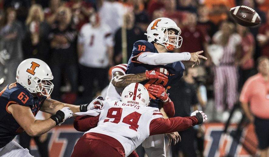 Illinois quarterback Brandon Peters (18) is hit by Nebraska's Khalil Davis (94) as he releases the ball in the second half of the team's NCAA college football game against Nebraska, Saturday, Sept. 21, 2019, in Champaign, Ill. (AP Photo/Holly Hart)