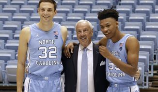 North Carolina coach Roy Williams poses for a photo with graduate transfers Justin Pierce (32) and Christian Keeling during the team&#39;s NCAA college basketball media day in Chapel Hill, N.C., Wednesday, Oct. 2, 2019. (AP Photo/Gerry Broome)