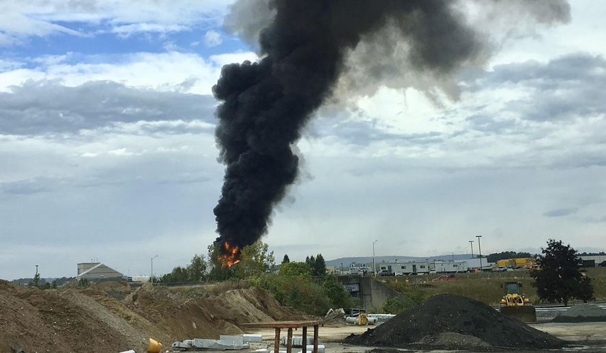 In this photo provided by Antonio Arreguin, smoke fills the sky after a World War II-era bomber plane crashed, Wednesday, Oct. 2, 2019, outside Bradley International Airport north of Hartford, Conn. A spokesman for Gov. Ned Lamont confirmed the crash of the B-17 plane. (Antonio Arreguin via AP)