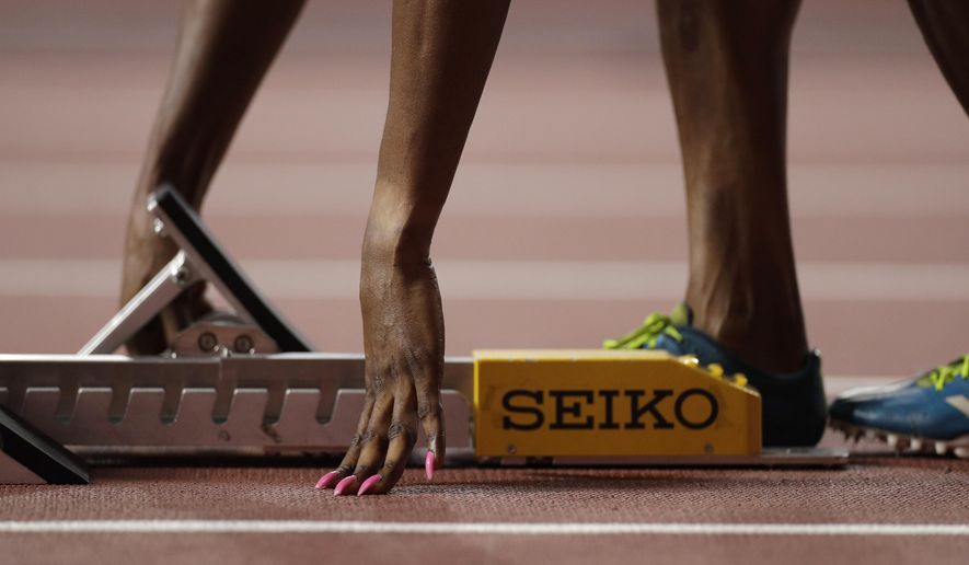 Patience Okon George, of Nigeria adjusts her starting blocks before a women's 400 meter heat at the World Athletics Championships in Doha, Qatar, Monday, Sept. 30, 2019. (AP Photo/Petr David Josek)