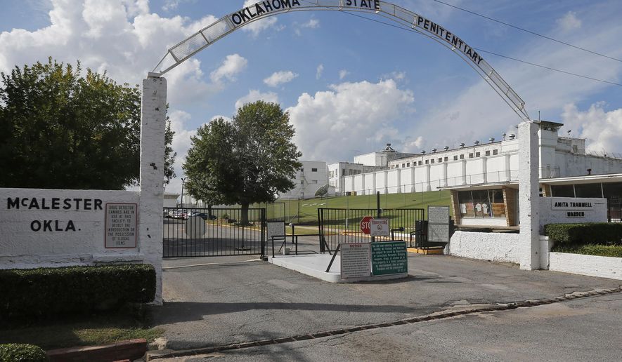 FILE - This Oct. 9, 2014, file photo shows the entrance to the Oklahoma State Penitentiary in McAlester, Okla. The Oklahoma Department of Corrections plans to move some of the 44 death row inmates housed at the prison's maximum-security H-Unit to another unit to give them more benefits and access to the outdoors. In a letter released Thursday, Oct. 3, 2019, from the agency's interim director to the American Civil Liberties Union of Oklahoma, the agency's interim Director Scott Crow says he plans to move "qualifying inmates" to another unit by the end of October.(AP Photo/Sue Ogrocki, File)