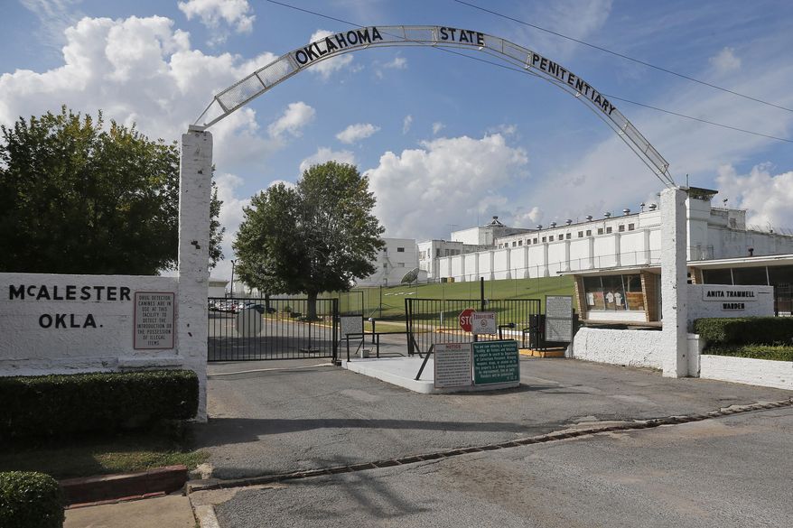 FILE - This Oct. 9, 2014, file photo shows the entrance to the Oklahoma State Penitentiary in McAlester, Okla. The Oklahoma Department of Corrections plans to move some of the 44 death row inmates housed at the prison's maximum-security H-Unit to another unit to give them more benefits and access to the outdoors. In a letter released Thursday, Oct. 3, 2019, from the agency's interim director to the American Civil Liberties Union of Oklahoma, the agency's interim Director Scott Crow says he plans to move "qualifying inmates" to another unit by the end of October.(AP Photo/Sue Ogrocki, File)