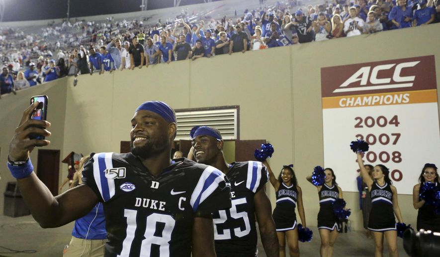 Duke quarterback Quentin Harris (18) and running back Deon Jackson (25) celebrate at the conclusion of an NCAA college football game against Virginia Tech, Friday, Sept. 27, 2019, in Blacksburg, Va. Duke won 45-10. (Matt Gentry/The Roanoke Times via AP)