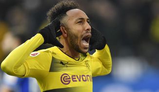 FILE - In this Saturday, Nov. 25, 2017 file photo Dortmund&#39;s then-striker Pierre-Emerick Aubameyang celebrates scoring the opening goal during the German Bundesliga soccer match between Borussia Dortmund and FC Schalke 04 in Dortmund, Germany. Former Borussia Dortmund striker Pierre-Emerick Aubameyang has called the club’s chief executive Hans-Joachim Watzke &#39;a clown&#39; for appearing to suggest he joined Arsenal for money. (AP Photo/Martin Meissner, file)