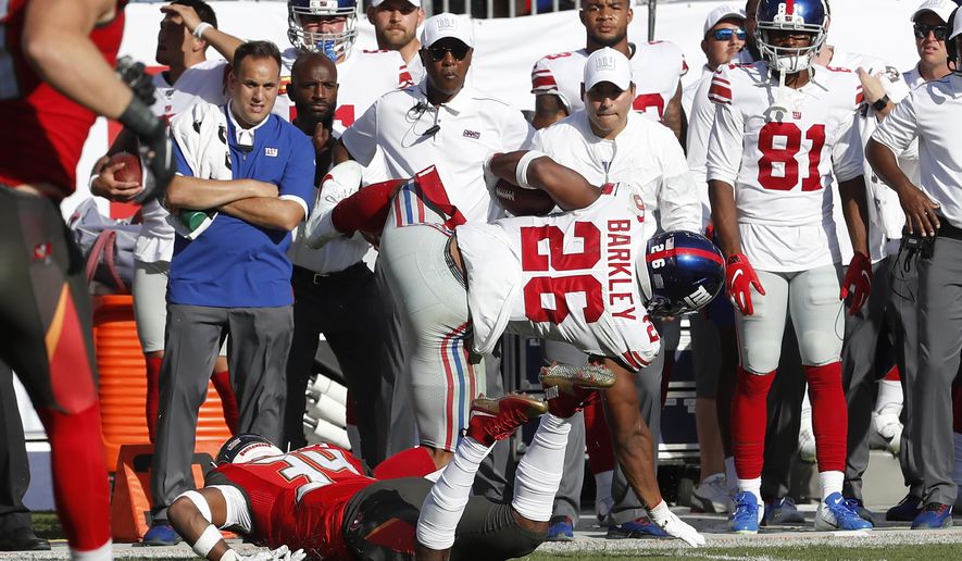 New York Giants running back Saquon Barkley (26) gets hit by Tampa Bay Buccaneers safety Mike Edwards during the first half of an NFL football game Sunday, Sept. 22, 2019, in Tampa, Fla. Barkley left the game. (AP Photo/Mark LoMoglio)