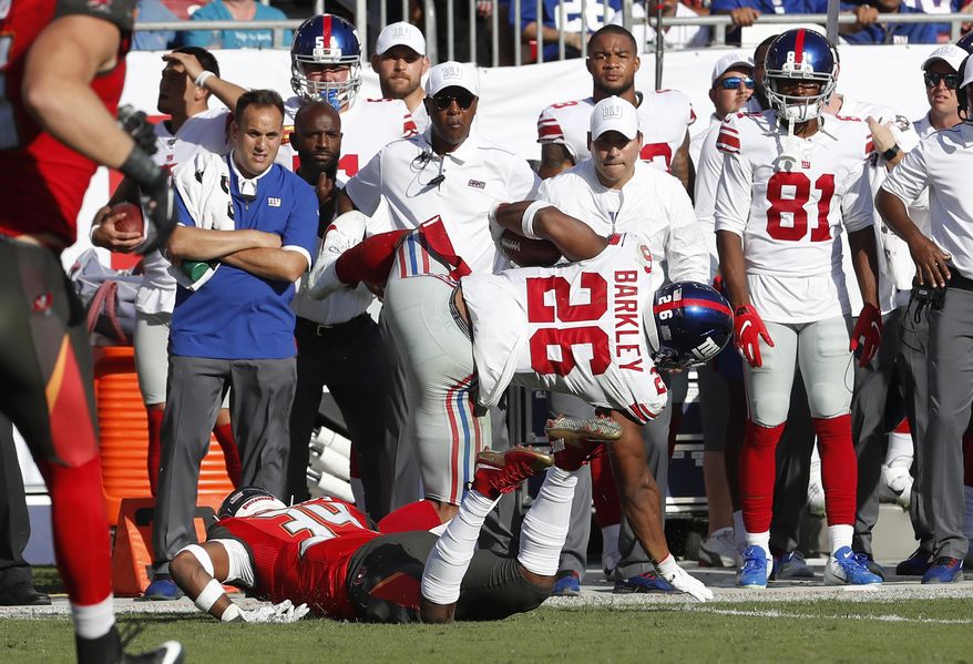 New York Giants running back Saquon Barkley (26) gets hit by Tampa Bay Buccaneers safety Mike Edwards during the first half of an NFL football game Sunday, Sept. 22, 2019, in Tampa, Fla. Barkley left the game. (AP Photo/Mark LoMoglio)