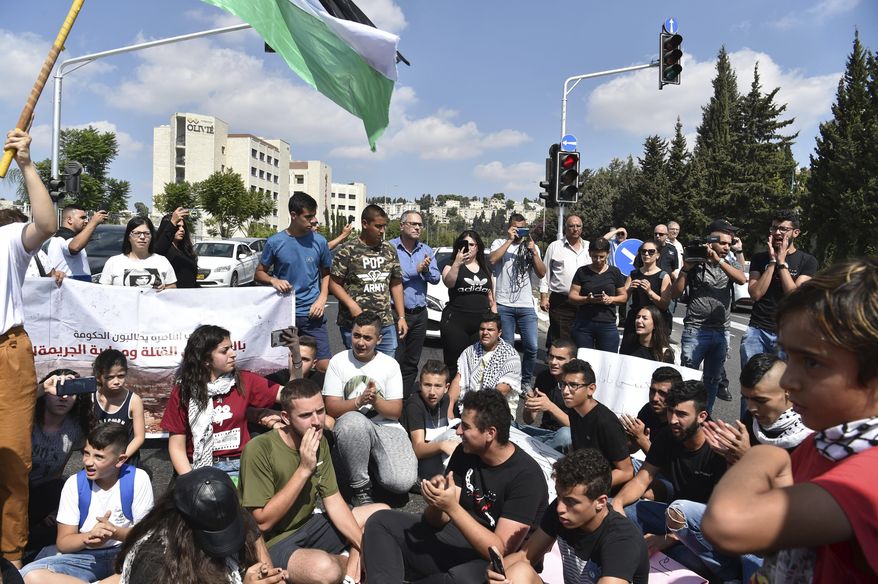 Israeli Arabs protest a wave of deadly violence within the minority community, in Nazareth, Israel, Thursday, Oct. 3, 2019. Police say there have been more than 70 killings in Arab communities this year, nearly as many as in each of the past two years, when Arabs made up more than half of all murder victims nationwide. (AP Photo/Gil Eliyahu-JINIPIX)