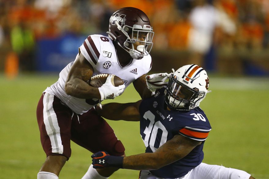 Mississippi State running back Kylin Hill (8) is tackled by Auburn linebacker Michael Harris (30) as he carries the ball during the second half of an NCAA college football game, Saturday, Sept. 28, 2019, in Auburn, Ala. (AP Photo/Butch Dill)