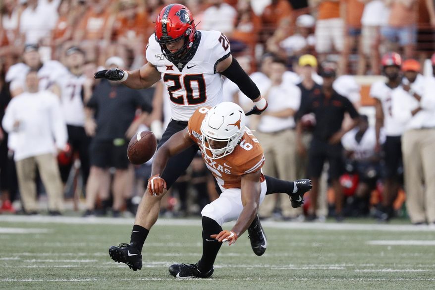 Oklahoma State safety Malcolm Rodriguez (20) breaks up a pass intended for Texas wide receiver Devin Duvernay (6) during the first half of an NCAA college football game Saturday, Sept. 21, 2019, in Austin, Texas. (AP Photo/Eric Gay)