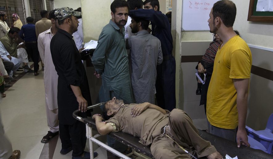 People wait to admite their family members suffering from dengue fever, a mosquito-borne disease, into a hospital in Rawalpindi, Pakistan, Thursday, Oct. 3, 2019. A top Pakistani health official says authorities are battling one of the worst-ever dengue fever outbreaks across the country, including the capital, Islamabad, as hospitals continued to receive scores of patients, putting strain on the poor emergency services. (AP Photo/B.K. Bangash)