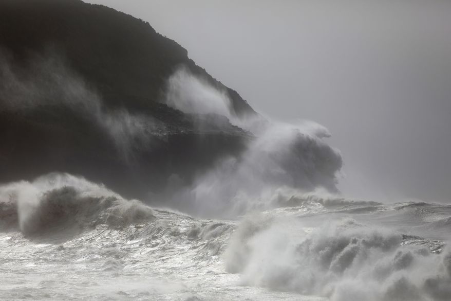 Waves crash against the rocks outside Horta, in the Portuguese island of Faial, Wednesday, Oct. 2, 2019. Hurricane Lorenzo powered across the Atlantic Ocean on Wednesday, lashing the Azores archipelago with heavy rains, powerful winds and high waves and significantly damaging one island's main port. (AP Photo/Joao Henriques)