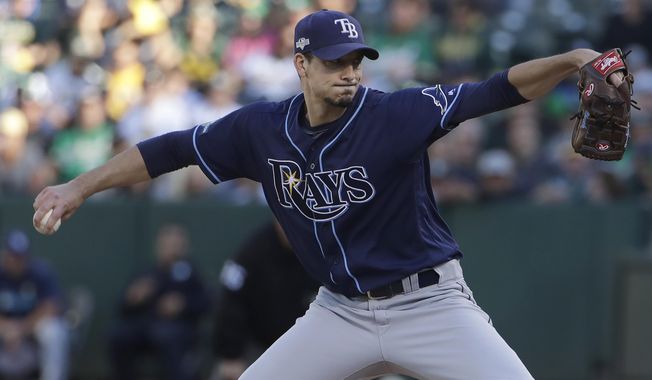 Tampa Bay Rays pitcher Charlie Morton throws to an Oakland Athletics batter during the first inning of an American League wild-card baseball game in Oakland, Calif., Wednesday, Oct. 2, 2019. (AP Photo/Jeff Chiu)
