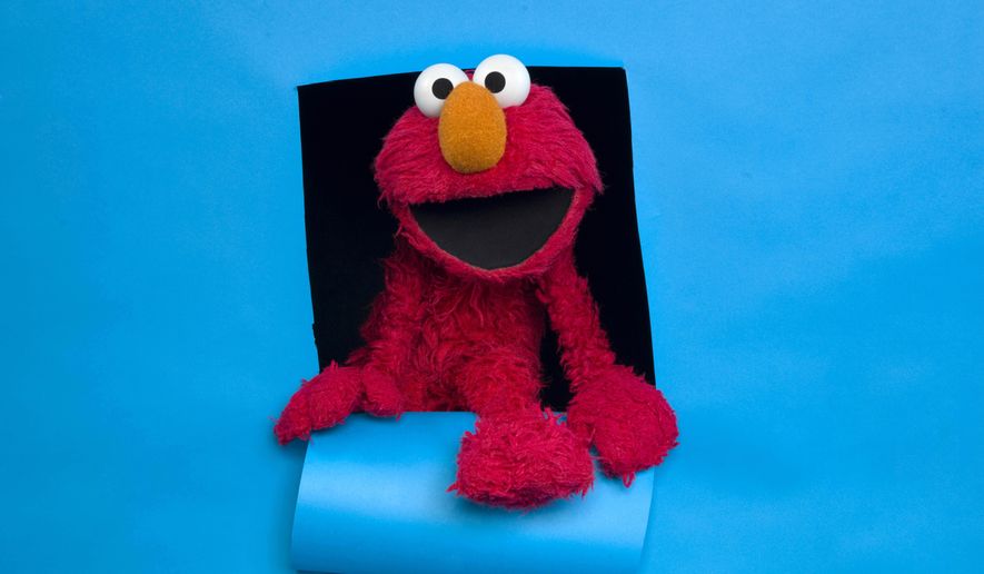 FILE - In this Jan. 24, 2011, file photo, Elmo of the film "Being Elmo" poses for a portrait in the Fender Music Lodge during the 2011 Sundance Film Festival in Park City, Utah. Sesame Workshop is developing a talk show starring Elmo, called "The Not Too Late Show with Elmo," where he will interview celebrity guests. Production will begin next month, although it's not clear when the program would make the air. It was announced Thursday as part of a deal between HBO Max and the children's television producer. (AP Photo/Victoria Will, File)