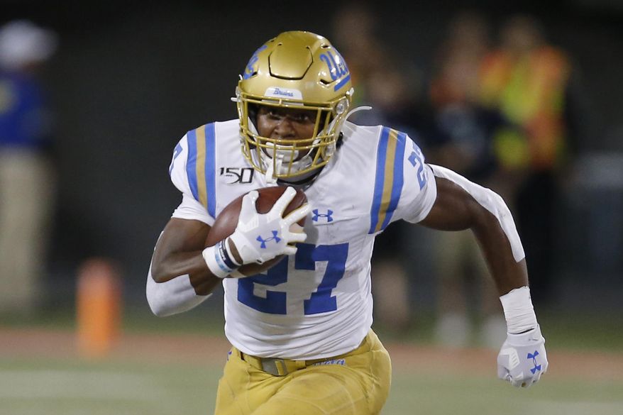 UCLA running back Joshua Kelley (27) runs for a first down against Arizona in the second half during an NCAA college football game, Saturday, Sept. 28, 2019, in Tucson, Ariz. Arizona defeated UCLA 20-17. (AP Photo/Rick Scuteri)