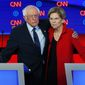 Sen. Bernie Sanders, I-Vt., and Sen. Elizabeth Warren, D-Mass., embrace after the first of two Democratic presidential primary debates in July, hosted by CNN in Detroit. (AP Photo/Paul Sancya) ** FILE **