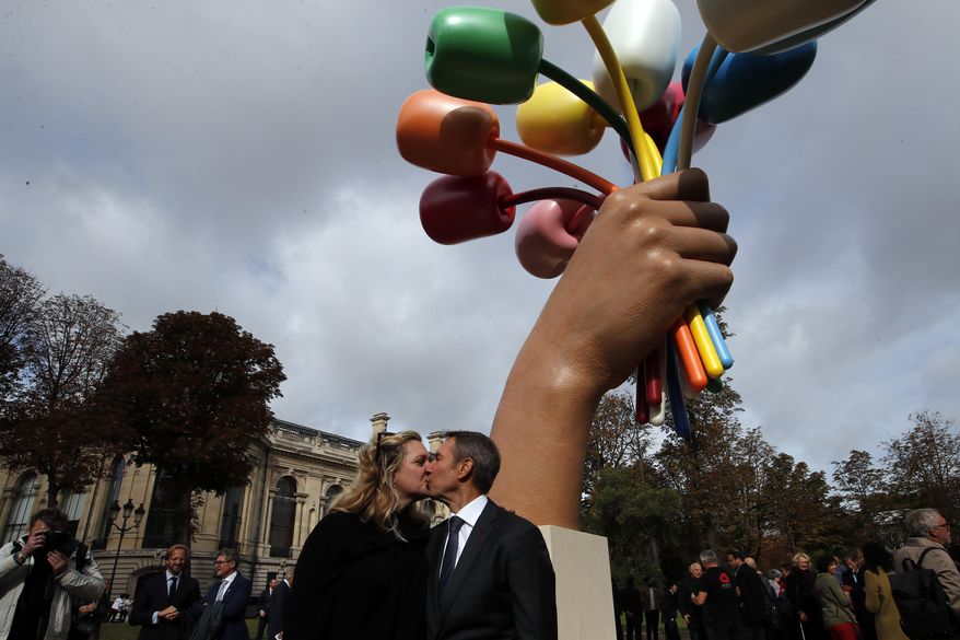 New York-based artist Jeff Koons poses with his wife Justine Wheeler as he unveiled his much-awaited and controversial sculpture &amp;quot;Bouquet of Tulips&amp;quot; dedicated to the victims of the terrorists attacks, in a garden next to the Champs Elysee near the Petit Palais museum in Paris, Friday, Oct. 4, 2019. (AP Photo/Francois Mori)
