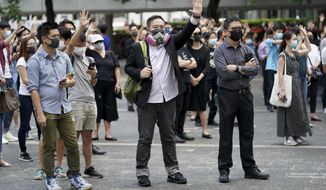 Protesters wear masks and hold up their hands represent the five demands in Hong Kong on Friday, Oct. 4, 2019. Hong Kong pro-democracy protesters marched in the city center ahead of reported plans by the city’s embattled leader to deploy emergency powers to ban people from wearing masks in a bid to quash four months of anti-government demonstrations. (AP Photo/Vincent Thian)