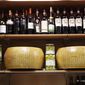 Wheels of parmesan cheese are on sale with spirits in a deli in Rome, Thursday, Oct. 3, 2019. The U.S. had prepared for Wednesday&#39;s ruling and already drawn up lists of the dozens of goods it would put tariffs on. They include EU cheeses, olives, and whiskey, as well as planes, helicopters and aircraft parts in the case _ though the decision is likely to require fine-tuning of that list if the Trump administration agrees to go for the tariffs. (AP Photo/Alessandra Tarantino)