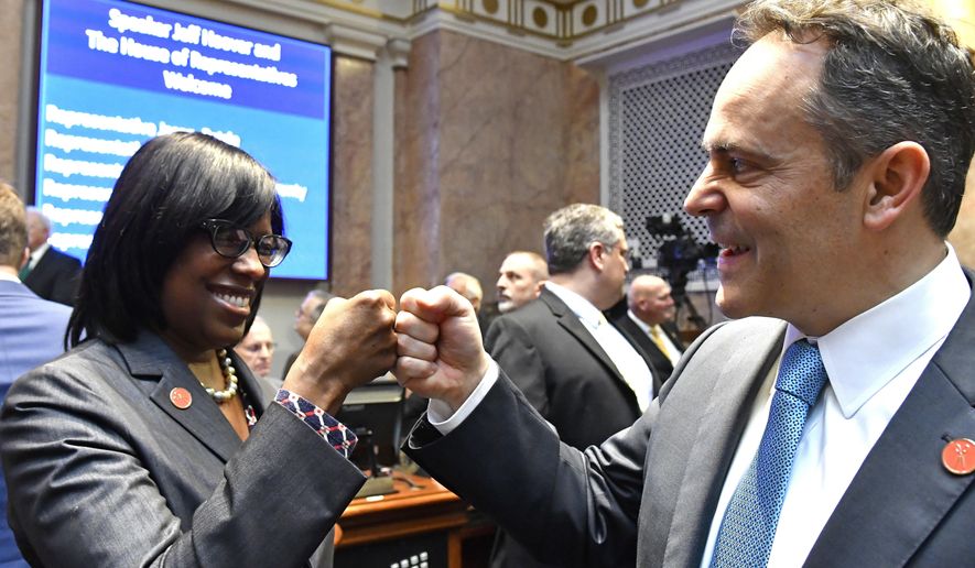 FILE - In this Jan. 3, 2017 file photo, Kentucky Gov. Matt Bevin, right, and Kentucky Lt. Governor Jenean Hampton bump fists as they await the swearing in of Jeff Hoover as Speaker of the Kentucky House of Representatives in Frankfort, Ky.  Hampton pushed back Friday, Oct. 4, 2019 against Bevin’s explanation for dropping her from his reelection ticket, saying she was unaware of any disagreements about her priorities until the governor discussed their political split at a tea party meeting. (AP Photo/Timothy D. Easley)