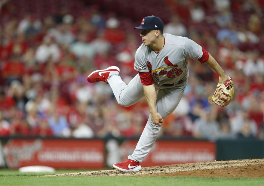 In this Aug. 15, 2019, file photo, St. Louis Cardinals relief pitcher Ryan Helsley throws against the Cincinnati Reds during the eighth inning of a baseball game in Cincinnati. Helsley was disappointed by his first exposure to the Atlanta Braves’ fans use of the Tomahawk Chop for their chants during games. Helsley’s vantage point is different than most players who visit SunTrust Park. He is a member of the Cherokee nation. (AP Photo/Gary Landers, File)