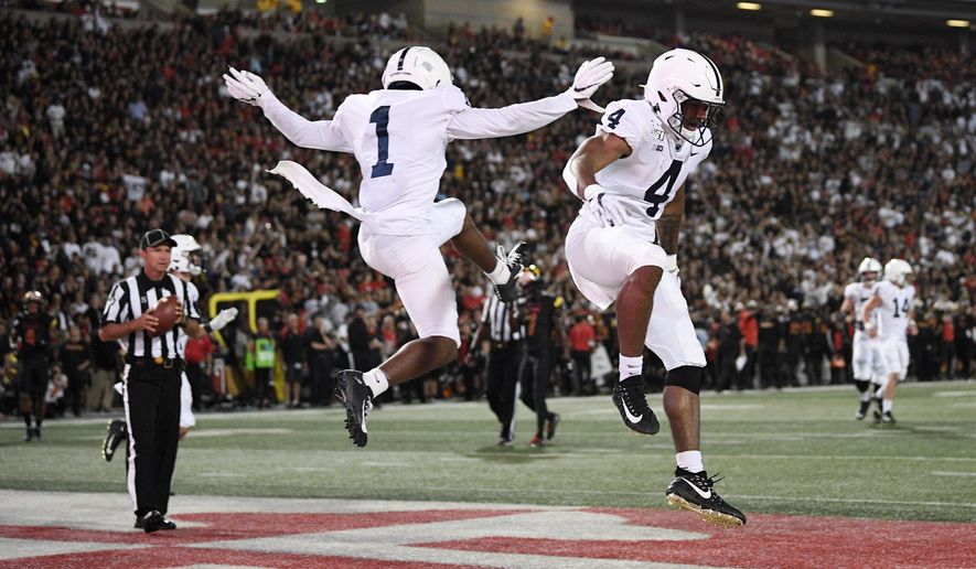 Penn State running back Journey Brown (4) celebrates his touchdown with wide receiver KJ Hamler (1) during the first half of an NCAA football game against Maryland, Friday, Sept. 27, 2019, in College Park, Md. (AP Photo/Nick Wass)