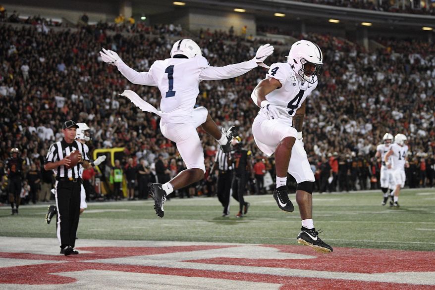 Penn State running back Journey Brown (4) celebrates his touchdown with wide receiver KJ Hamler (1) during the first half of an NCAA football game against Maryland, Friday, Sept. 27, 2019, in College Park, Md. (AP Photo/Nick Wass)