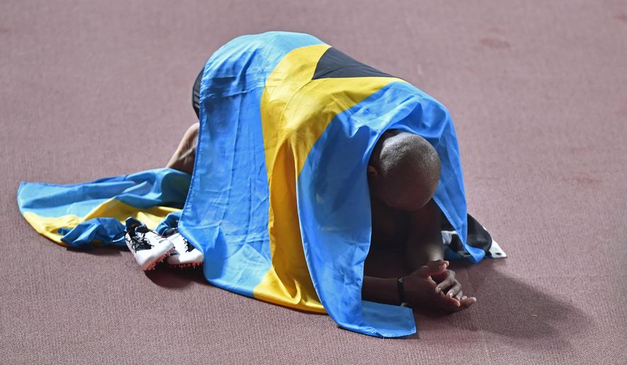 Gold medallist Steven Gardiner, of Bahamas, celebrates winning the men's 400 meter at the World Athletics Championships in Doha, Qatar, Friday, Oct. 4, 2019. (AP Photo/Martin Meissner)