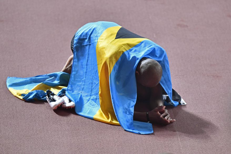 Gold medallist Steven Gardiner, of Bahamas, celebrates winning the men's 400 meter at the World Athletics Championships in Doha, Qatar, Friday, Oct. 4, 2019. (AP Photo/Martin Meissner)